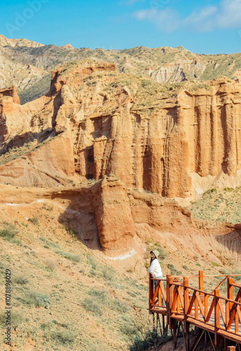 Asian woman enjoying the beautiful landscape of Aksu Wensu Grand Canyon National Geopark in autumn season in Aksu, Xinjiang.
 photo