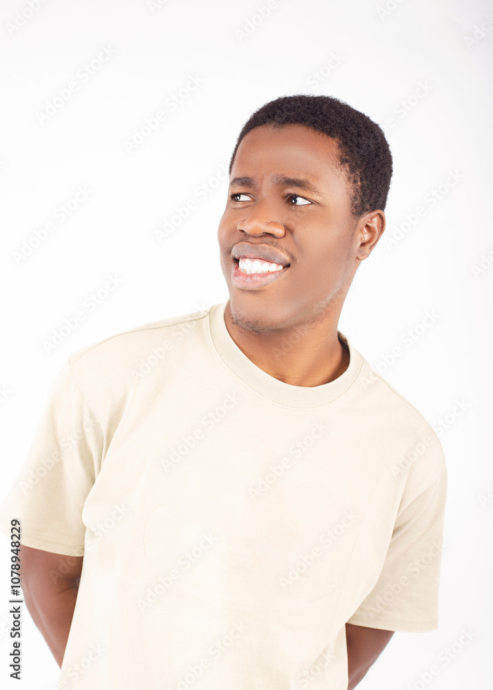 Young Man with Confused Expression Against White Background Young Man with Confused Expression Against White Background