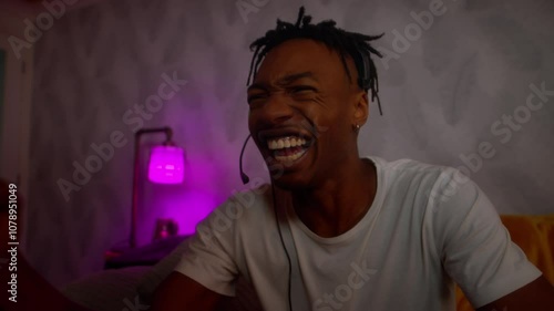 Young black male playing video games celebrates emphatically slow motion