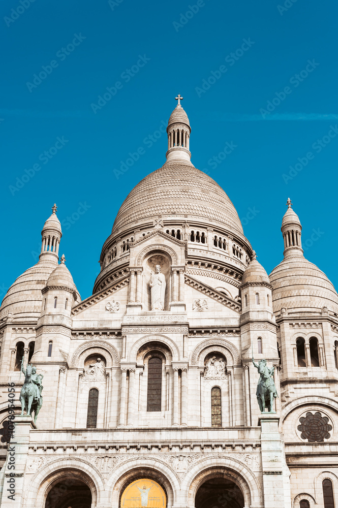 Paris, France - September 25, 2024: The Basilica of Sacre Coeur de Montmartre, commonly known as Sacre-Coeur Basilica, is a Catholic church, minor basilica in Paris dedicated to Sacred Heart of Jesus Paris, France - September 25, 2024: The Basilica of Sacre Coeur de Montmartre, commonly known as Sacre-Coeur Basilica, is a Catholic church, minor basilica in Paris dedicated to Sacred Heart of Jesus