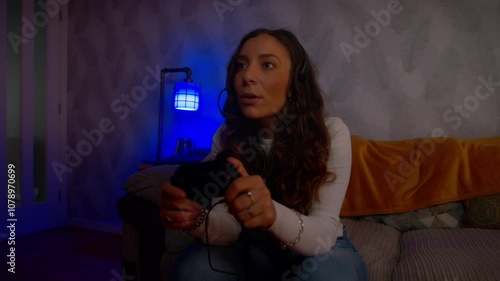 Young Italian woman playing video games celebrates emphatically