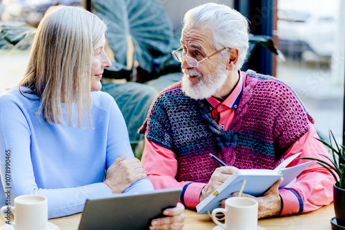 Close-up View at Older Business Person who is Enjoying in Morning Cafe Garden. photo