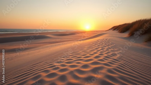 Scenic view of sandy dune system on beach with glowing sunrise, beach photo