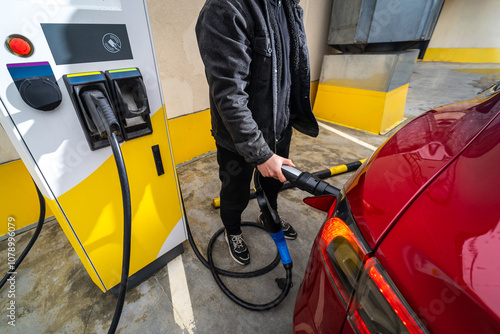 Electric Vehicle Charging Station with Plugged Cable