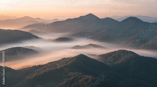 Misty mountain peaks at sunrise.