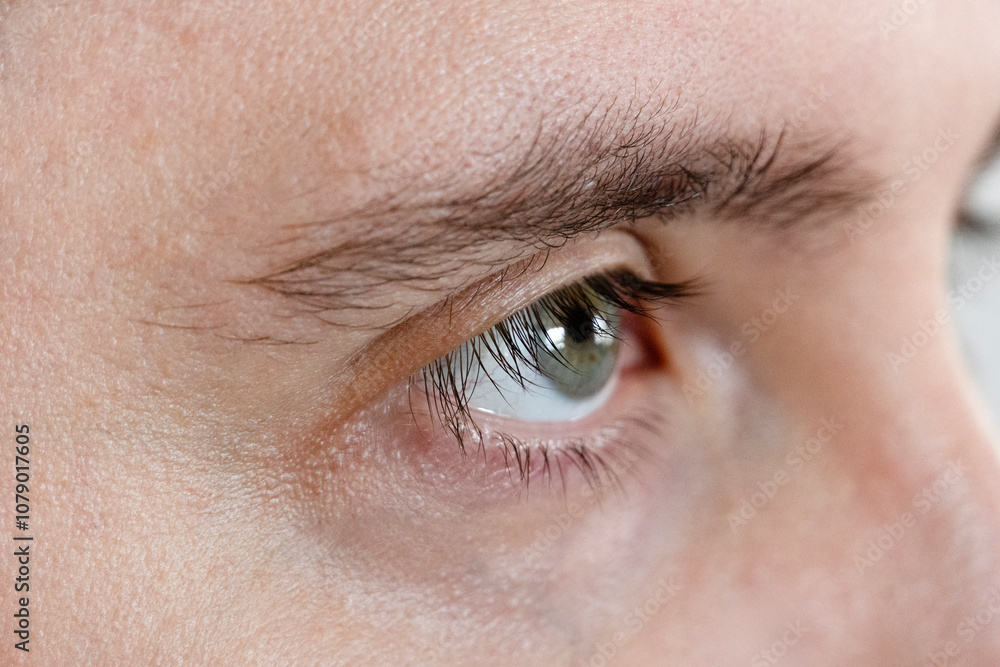 Obraz premium Macro Studio Expression Shot Of man's green Eye With Close Up On Eyelashes And Pupil