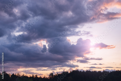 Vibrant, pink clouds in the sky at sunset. Beautiful evening sky landscape. Abstract, purple and pink background. Vivid color photography