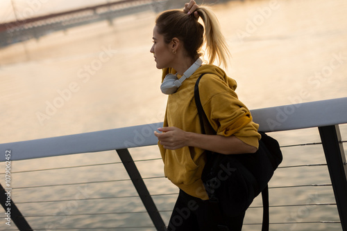 A joyful woman strolls alon...