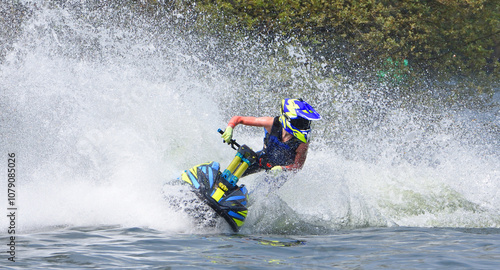 Female Jet Ski racer cornering at speed creating at lot of spray photo