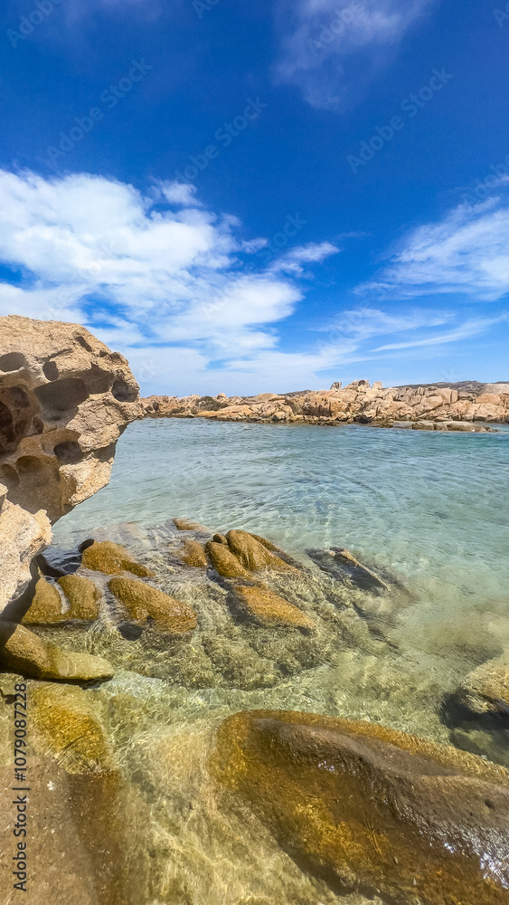 Fototapeta premium Beautiful beach, amazing water, surrounded by rocks.