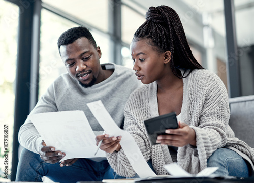 Billede på lærred Apartment, black couple and calculator with paperwork on sofa for finance plan or interest rate on loan application