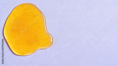  Close-up of a yellow object on a blue surface with water droplets on top