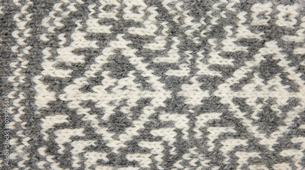 Above view of gray and white traditional knitted pattern. Background texture concept. Above view of gray and white traditional knitted pattern. Background texture concept.
