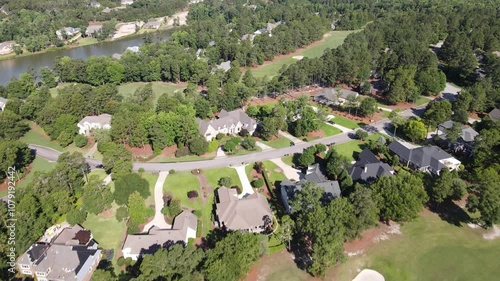 Suburban neighborhood captured by drone in California, USA, showing green lawns, residential houses, and tree-filled surroundings, highlighting a peaceful, scenic community landscape