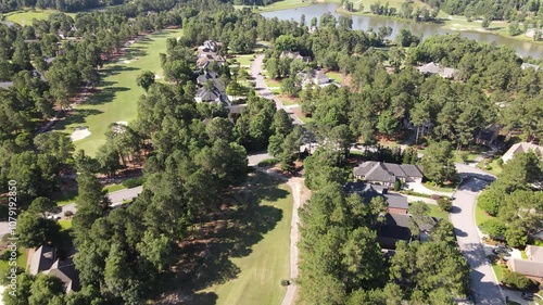 Suburban neighborhood captured by drone in California, USA, showing green lawns, residential houses, and tree-filled surroundings, highlighting a peaceful, scenic community landscape