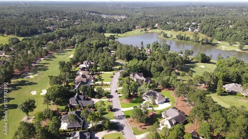 Suburban neighborhood captured by drone in California, USA, showing green lawns, residential houses, and tree-filled surroundings, highlighting a peaceful, scenic community landscape