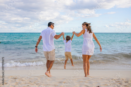 Happy family on the tropical beach. Family vacation