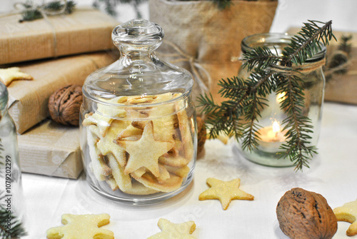 Slika na platnu A glass jar with shortbread homemade cookies, next to the Christmas decor, a festive atmosphere