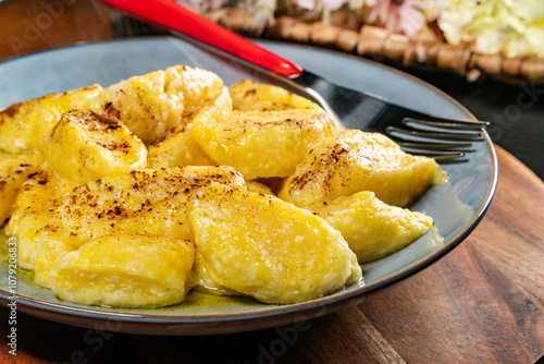 Homemade lazy noodles with cheese, crumbs and melted butter.