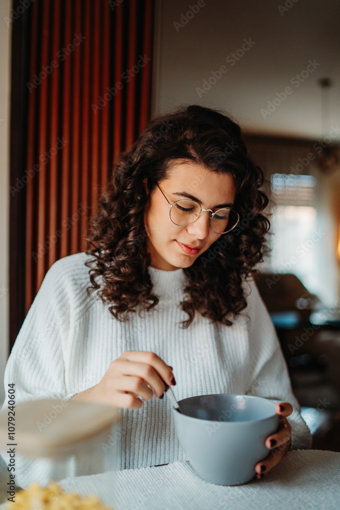 Young caucasian woman eating corn flakes for breakfast at home Young caucasian woman eating corn flakes for breakfast at home