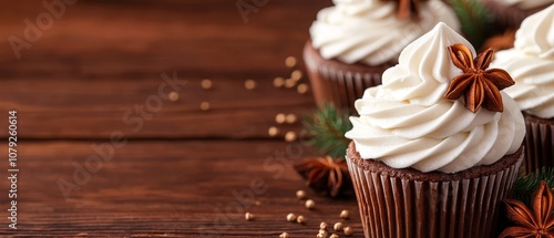 A close up of a cupcake with white frosting and anise stars