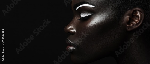  A close up of a woman's face with black makeup