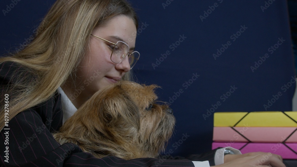 Young blonde caucasian business woman working from home and holding her pet dog. High quality photo Young blonde caucasian business woman working from home and holding her pet dog. High quality photo