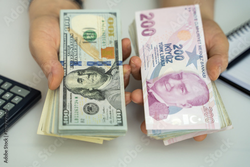 American dollar and Turkish lira in a woman's hand. (focus is special) photo