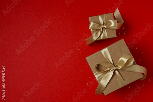 Beautiful gift boxes tied with bows on color background 