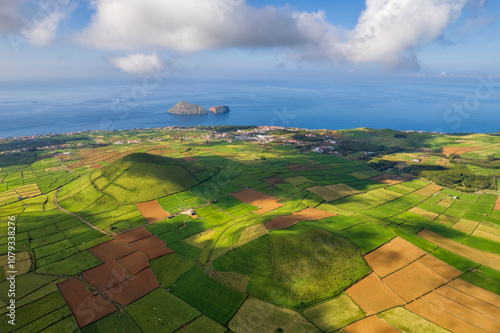 Aerial view of craters and farm fields, in the green Terceira island, Azores, Portugal. Geometric lines in the volcanic landscape. Drone point of view.