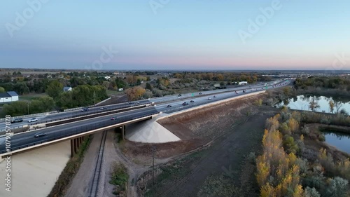 Evening traffic on I-25 interstate freeway near Fort Collins, Colorado, fall scenery at dusk