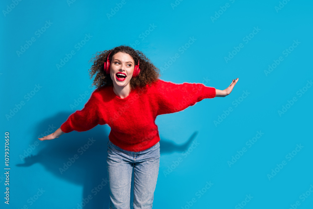 Photo portrait of lovely young lady headphones dance have fun dressed stylish red garment isolated on blue color background