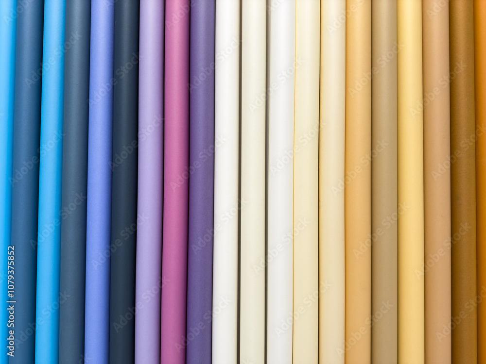 A row of colorful paper tubes, each a different color A row of colorful paper tubes, each a different color