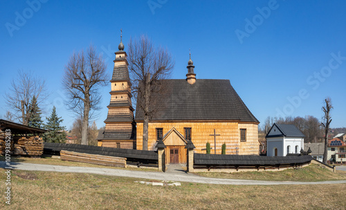 Obraz na płótnie Old wooden church of Saint Andrew in Roznowice in Poland. Built in 18th century. High tower. Roof covered with shingles w salonie