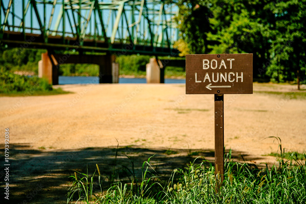 Boat launch sign at Wisconsin River at Spring Green, Wisconsin with highway bridge in background Boat launch sign at Wisconsin River at Spring Green, Wisconsin with highway bridge in background