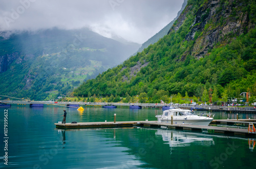 Obraz na płótnie View on the coast and port of Geirangerfjord in town Geiranger, one of the most beautiful fjords in Norway w salonie