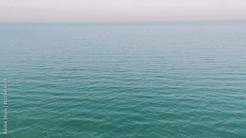 A stunning view of tranquil ocean waters lapping the horizon, perfect for relaxation and escaping daily life A stunning view of tranquil ocean waters lapping the horizon, perfect for relaxation and escaping daily life