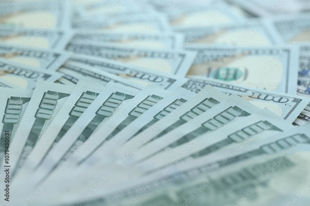 Many hundred dollar bills new banknotes in big pile under the natural light Many hundred dollar bills new banknotes in big pile under the natural light