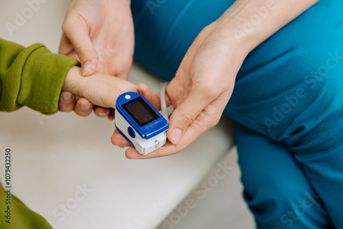 Healthcare professional checking childs vitals with a pulse oximeter for accurate monitoring photo