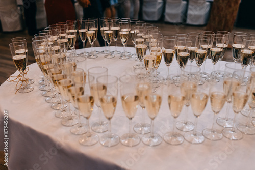 Champagne glasses arranged in heart shape during the wedding