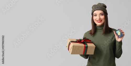 Pretty young woman holding ...