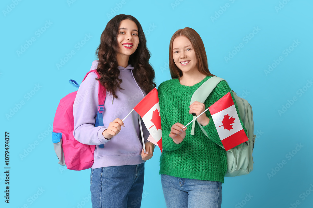Female students with backpacks and flags of Canada on blue background Female students with backpacks and flags of Canada on blue background