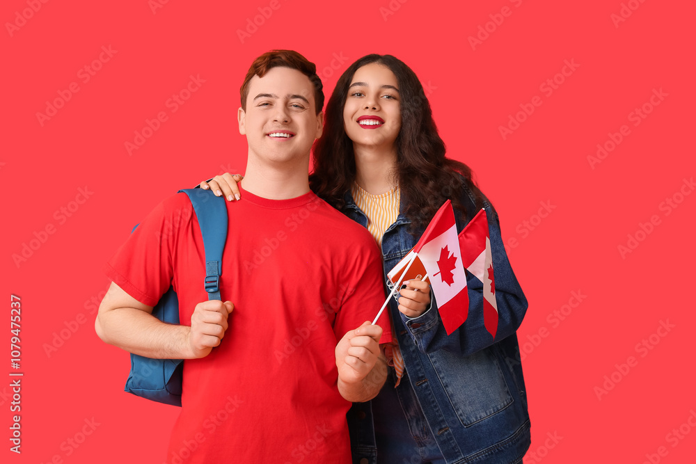 Students with flags of Canada, backpack and notebook on red background Students with flags of Canada, backpack and notebook on red background