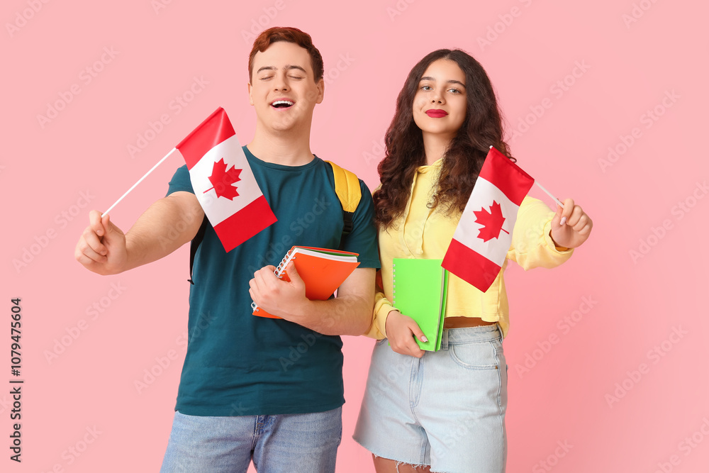 Students with flags of Canada and notebooks on pink background Students with flags of Canada and notebooks on pink background