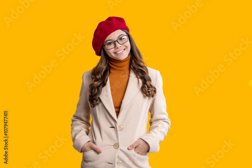 Autumn mood of adolescent model. Autumn girl isolated on yellow. Trendy stylish girl. Autumn teen girl wearing in glasses and beret. Fall color in trend. Fall season. Girl stylish in fall