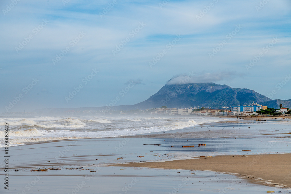 Expansive Beach Scene with Waves and Misty Mountain Background Expansive Beach Scene with Waves and Misty Mountain Background