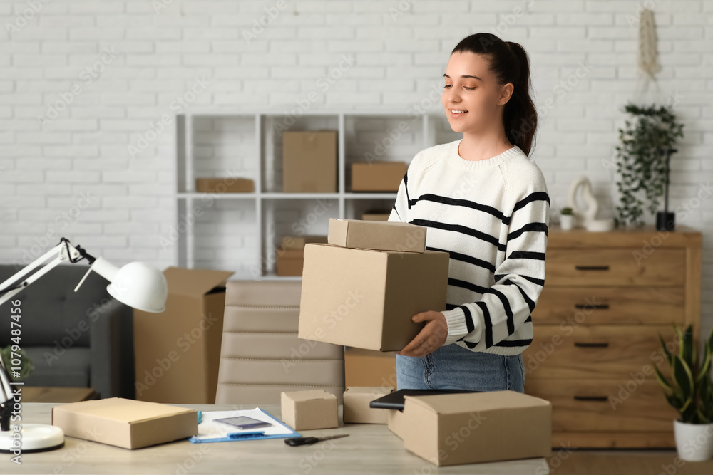 Young woman putting parcel boxes on table in warehouse Young woman putting parcel boxes on table in warehouse