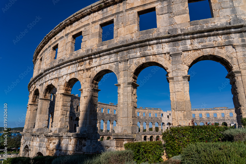 Obraz premium Pula, Croatia - November 3, 2024: View of the Amphitheater (Ancient Arena, Colosseum) monument of ancient Roman history and architecture.