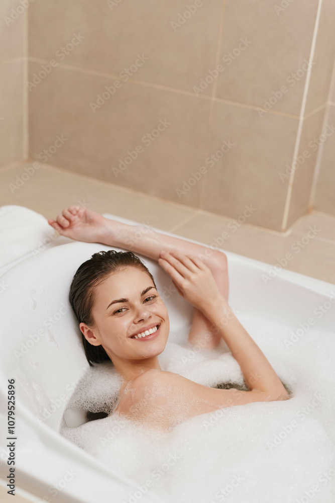 Relaxed young woman enjoying a bubble bath, smiling while soaking in warm water. Self-care and wellness concept in a cozy bathroom setting. Relaxed young woman enjoying a bubble bath, smiling while soaking in warm water. Self-care and wellness concept in a cozy bathroom setting.
