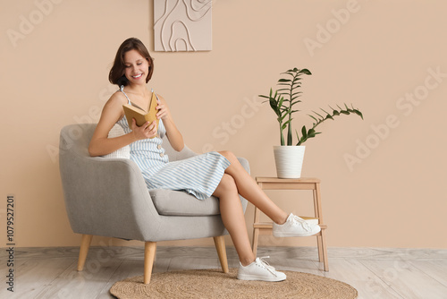 Smiling young woman reading...